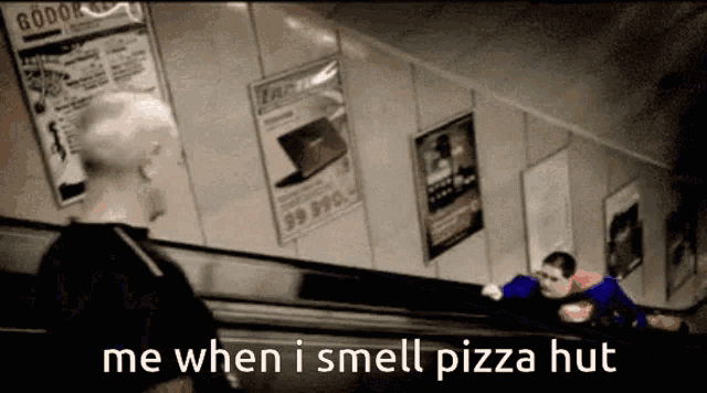 a man in a superman costume is talking to another man on a escalator .