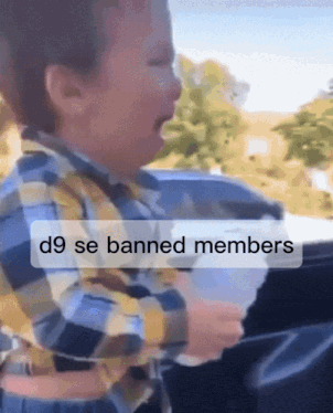 a child is crying in a car with the words d9 se banned members above him