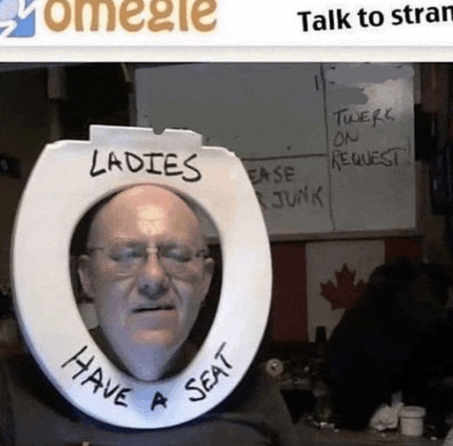 a man is wearing a toilet seat that says have a seat