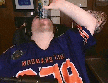 a man wearing a blue jersey with the number 78 on it drinks from a can