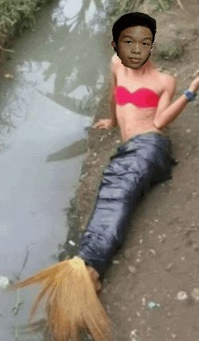 a man in a red bra is sitting next to a stream