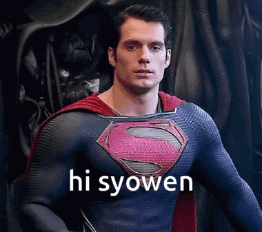 a man in a superman costume is standing in front of a black curtain and says hi syowen