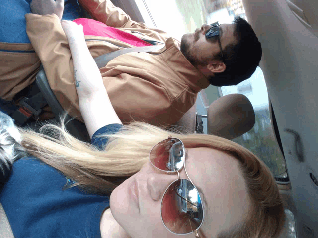 a man and a woman are sitting in a car