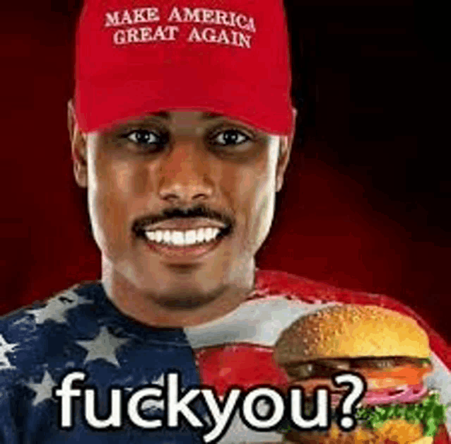 a man wearing a make america great again hat and holding a hamburger .