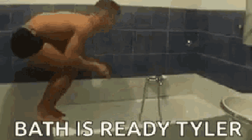 a shirtless man is jumping into a bathtub with the words `` bath is ready tyler '' .