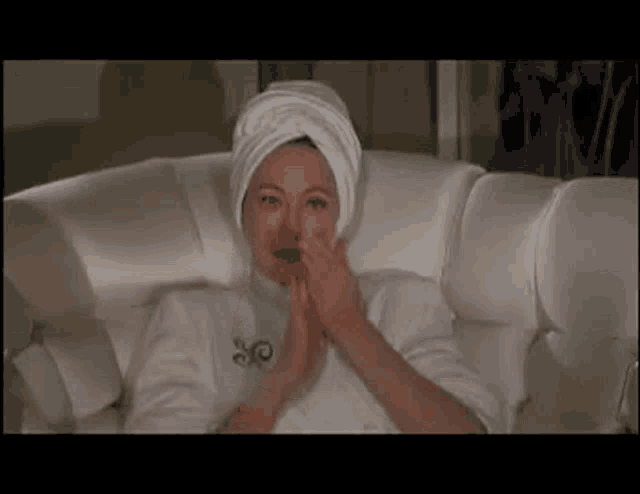 a woman in a bathtub with a towel wrapped around her head