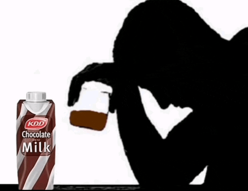 a bottle of kdd chocolate milk is next to a person holding a glass