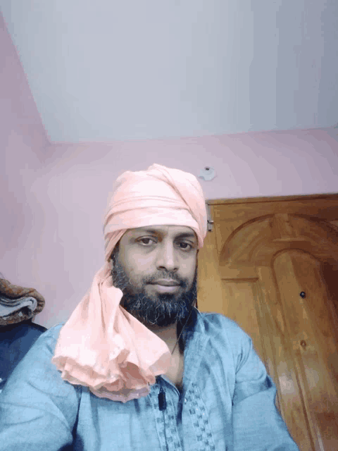 a man with a beard wearing a head scarf