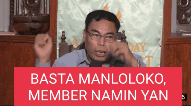 a man speaking into a microphone with the words basta manloloko member namin yan