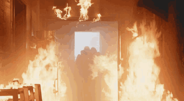 a doorway is surrounded by flames and smoke coming out of it