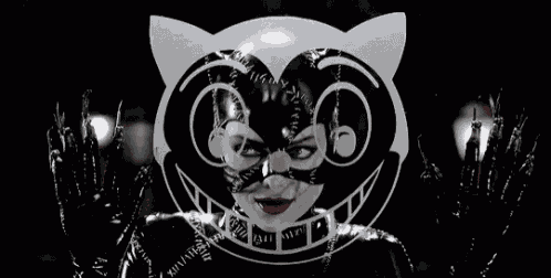 a woman in a catwoman costume with a cat mask on her face .