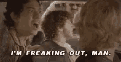 a group of people are sitting in a car talking to each other and one of them is screaming .