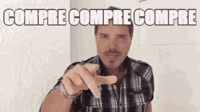 a man in a plaid shirt is pointing at the camera and the words compre compre compre are written above him .