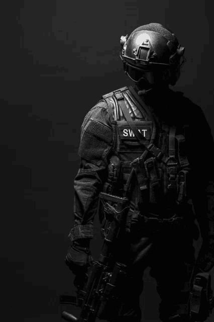 a swat officer with a helmet and a gun