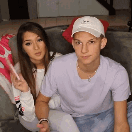 a man and a woman are sitting on a couch together .