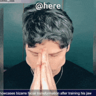 a man covering his face with his hands and the words @here above him