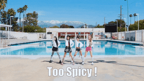 a group of girls are standing in front of a swimming pool with the words too spicy written on the ground