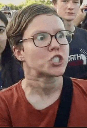 a man wearing glasses is making a funny face with his mouth open .