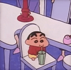 a cartoon character is sitting on a chair drinking a milkshake .