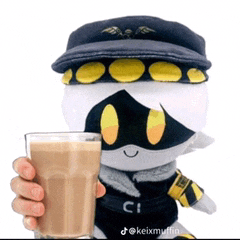 a stuffed animal wearing a hat is holding a glass of coffee