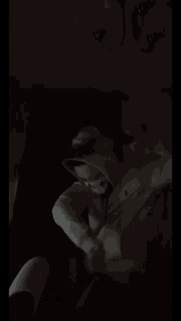 a person wearing a white hat and a white shirt with the word prada on the front