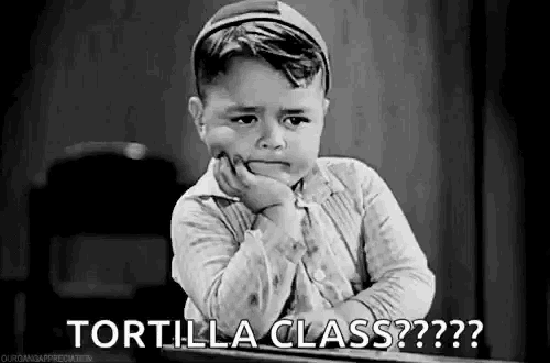 a black and white photo of a little boy sitting at a desk with his hand on his chin and the words `` tortilla class '' .