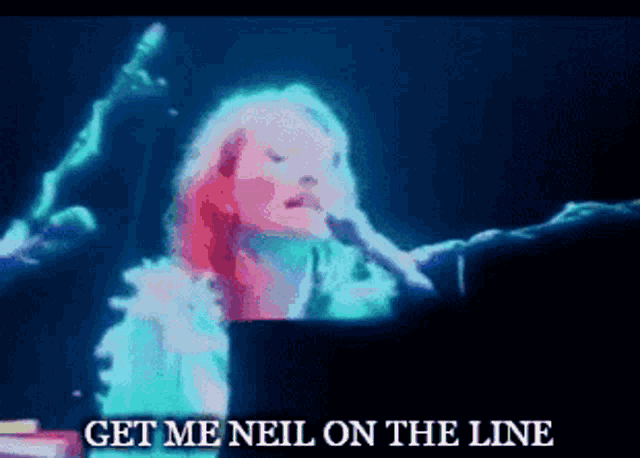 a woman singing into a microphone with the words " get me neil on the line " below her