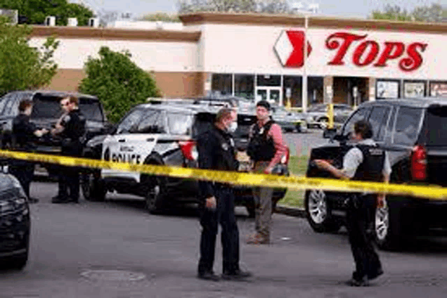 a group of police officers are standing in front of a tops store .