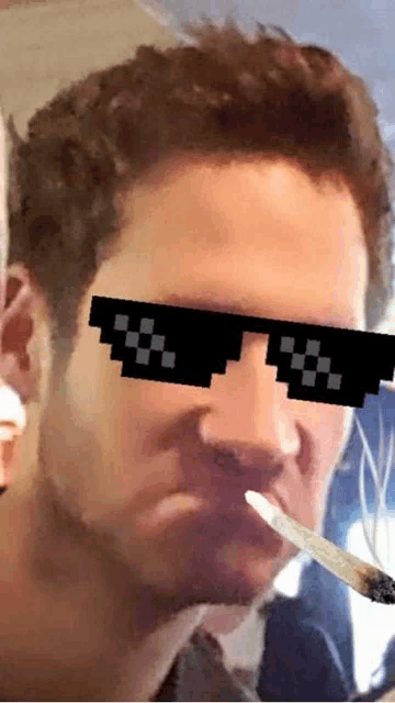 a man wearing pixelated sunglasses holds a knife in his mouth