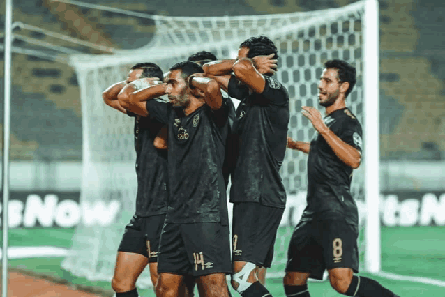 a group of soccer players are celebrating a goal with the number 8 on their jersey