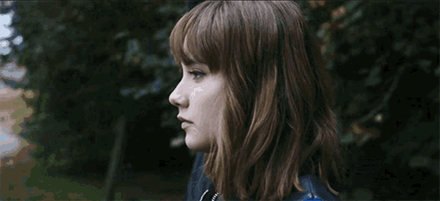 a group of people standing next to each other with one wearing glasses