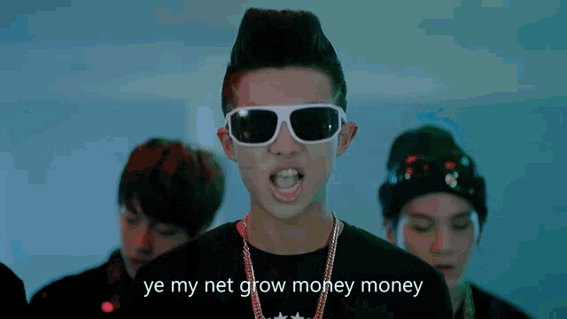 a young man wearing sunglasses and a mohawk says " ye my net grow money money "