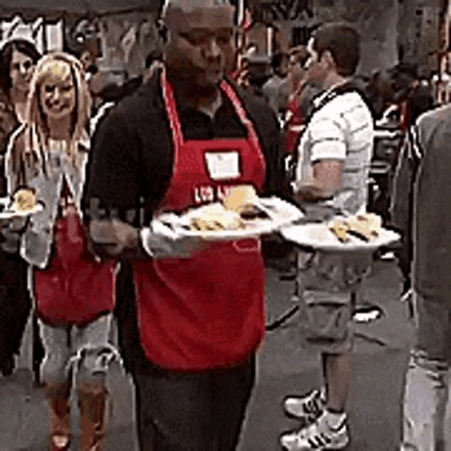 a man in a red apron that says los angeles on it