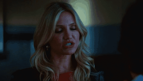 a woman with long blonde hair is talking to a man