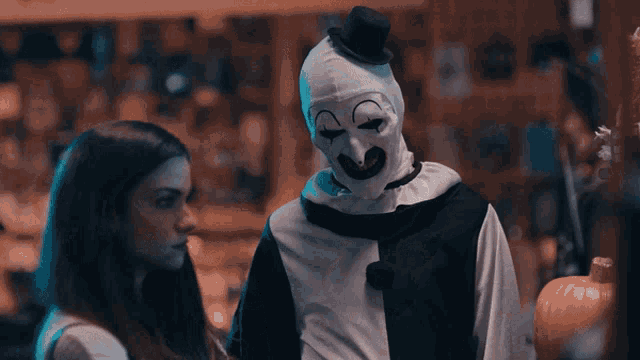 a clown is standing next to a woman behind a counter in a store