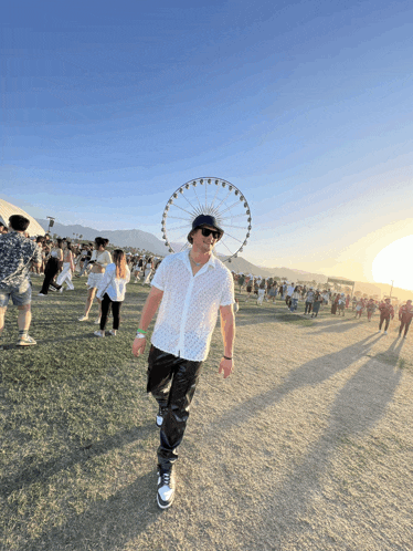 a man with a ferris wheel in the background