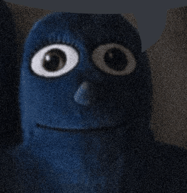 a close up of a blue cartoon character with big eyes and a smiling face .