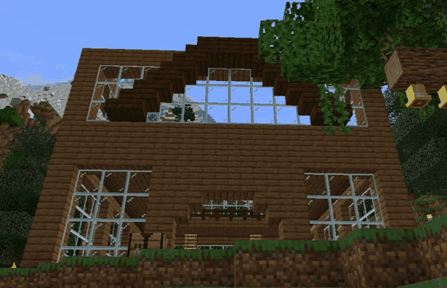 a minecraft house with a lot of windows and a tree in front of it