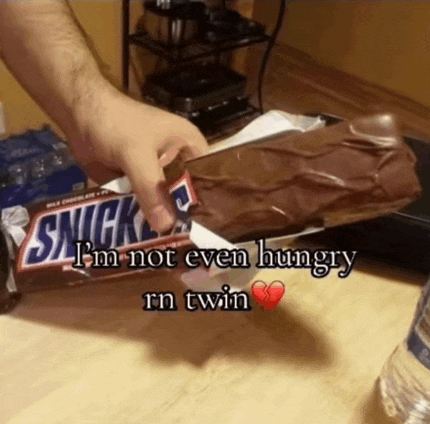 a person is holding a snickers bar with the words i 'm not even hungry rn twin below it