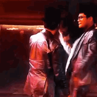 two men are standing next to each other on a stage .