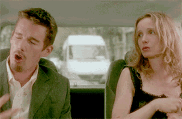 a man and a woman are sitting in a car