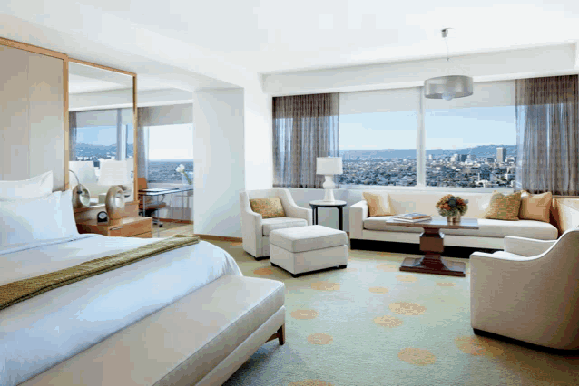 a hotel room with a view of the city and mountains