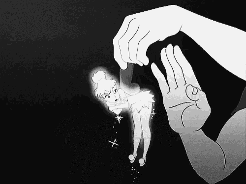 a black and white drawing of a hand holding a tinkerbell doll