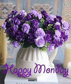 a vase filled with purple roses and the words `` happy monday ''