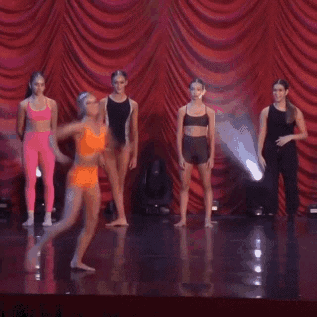 a blurry picture of a woman in an orange dress dancing