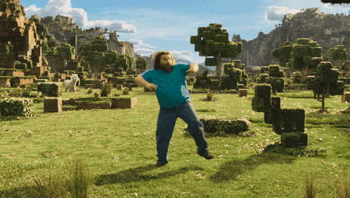 a man in a blue shirt is dancing in a field with trees in the background