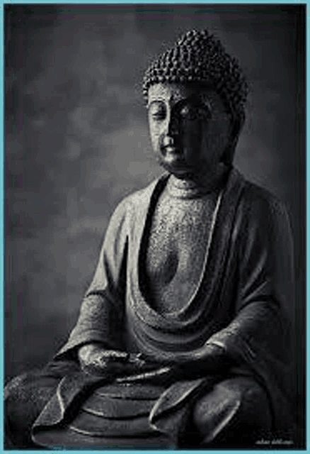 a black and white photo of a statue of a buddha sitting down .