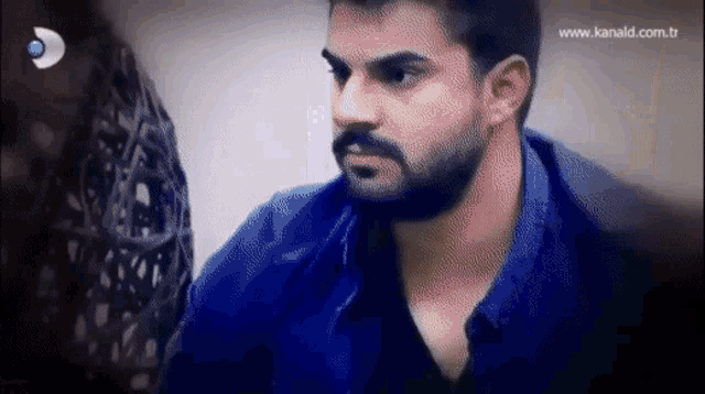 a man with a beard is on a tv screen with the website www.kanald.com.tr on the bottom