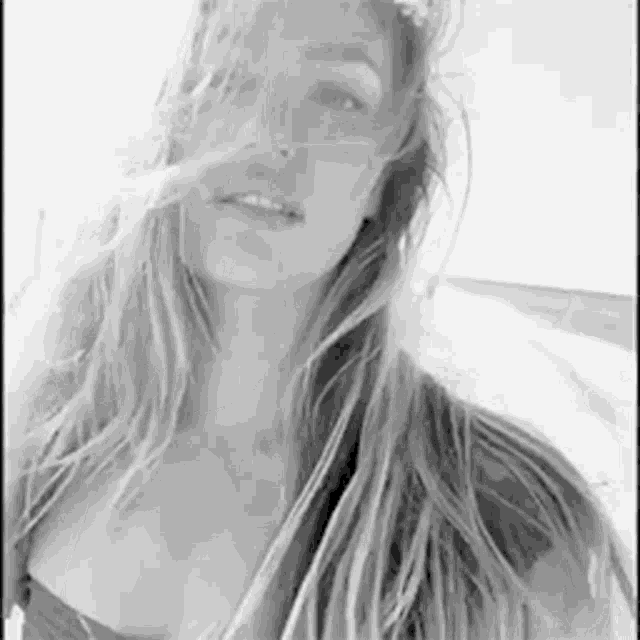 it is a black and white photo of a woman with long hair .