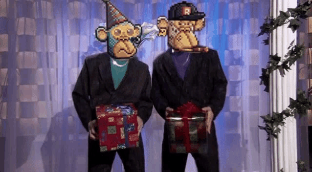 two men in suits and hats are holding gifts .